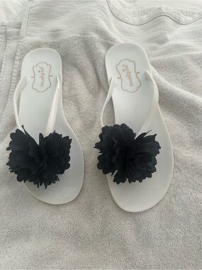 Mud Pie White Flip Flop Sandals with Black Flower Embellishments